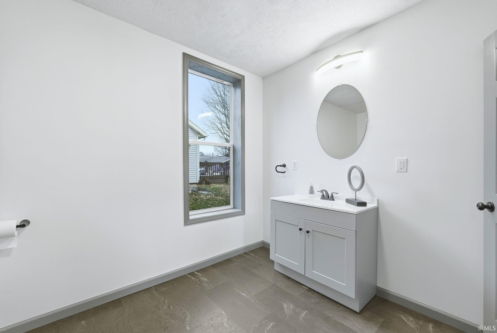 Bathroom featuring vanity and a textured ceiling