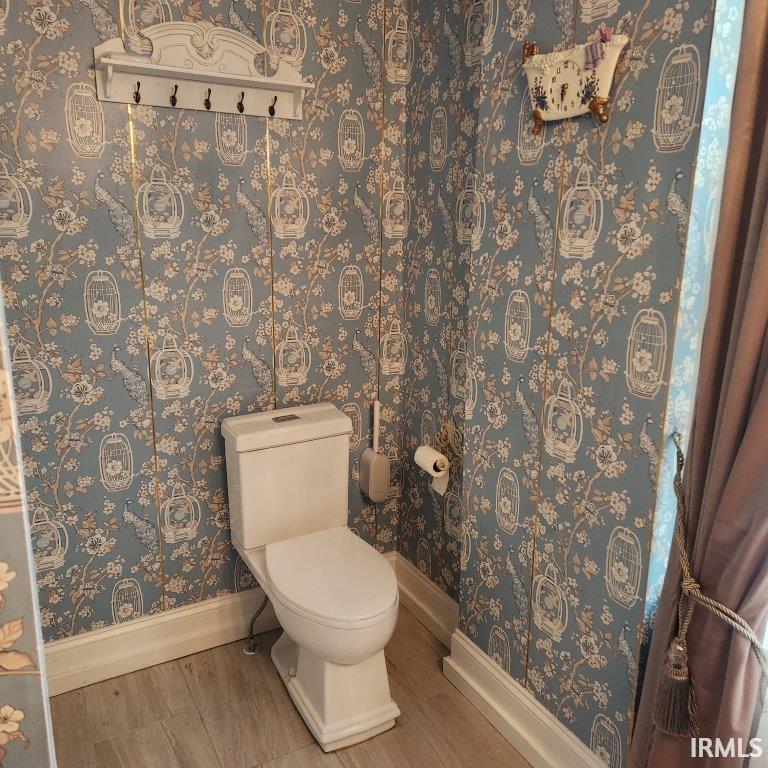 Bathroom featuring toilet and baseboards