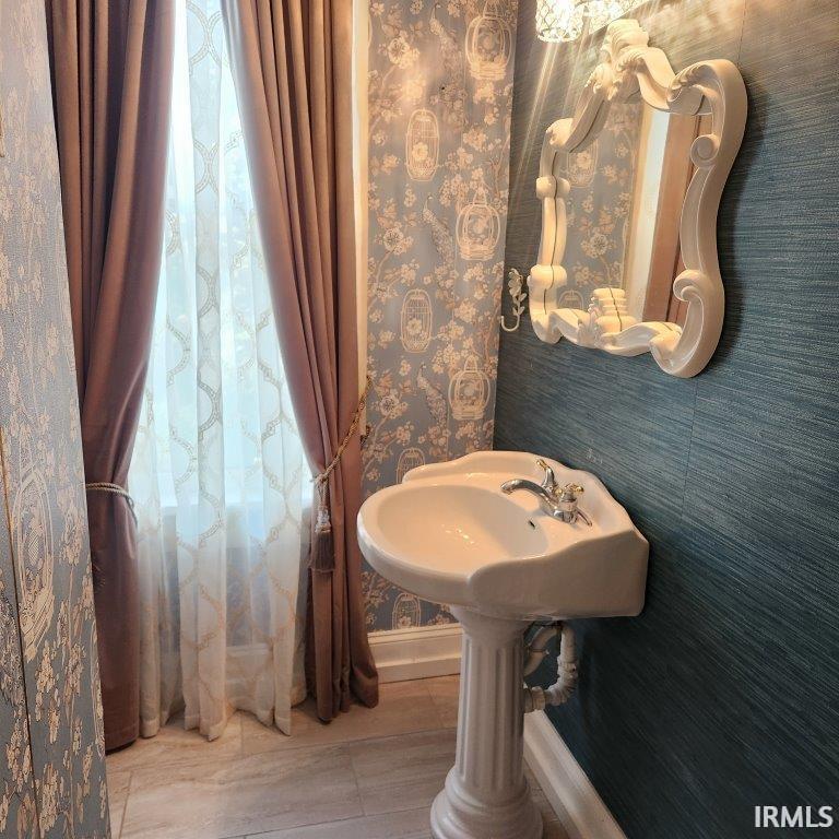 Bathroom featuring wallpapered walls