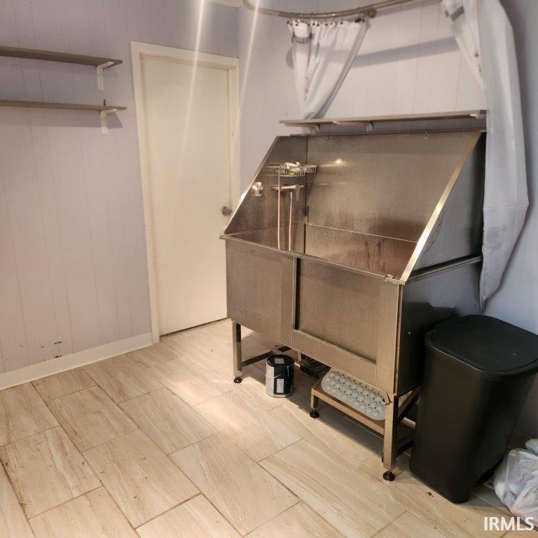 Detailed view of pet washing area and wooden walls