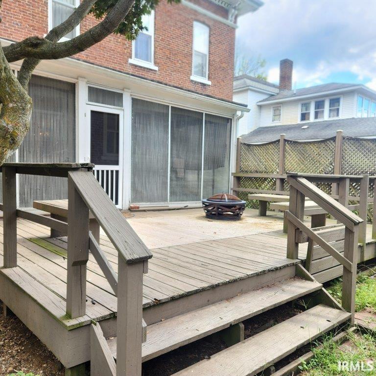 Wooden terrace with an outdoor fire pit