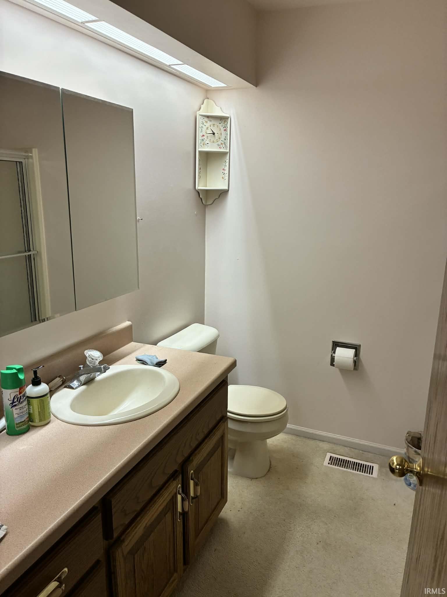Bathroom featuring vanity and baseboards