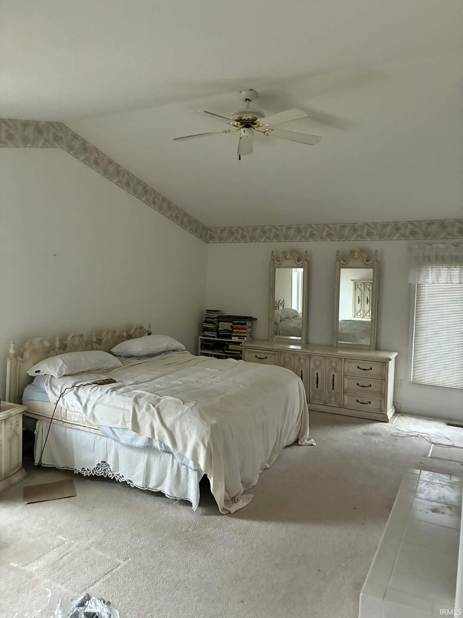 Bedroom featuring carpet floors, a ceiling fan, and vaulted ceiling