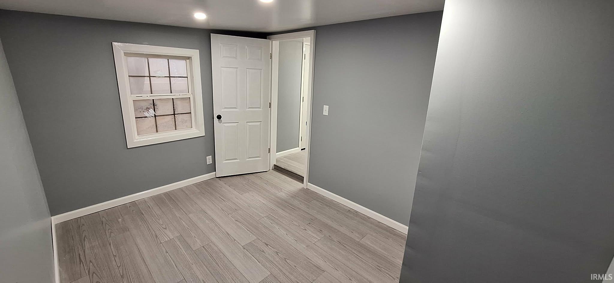 Spare room featuring light wood finished floors and recessed lighting