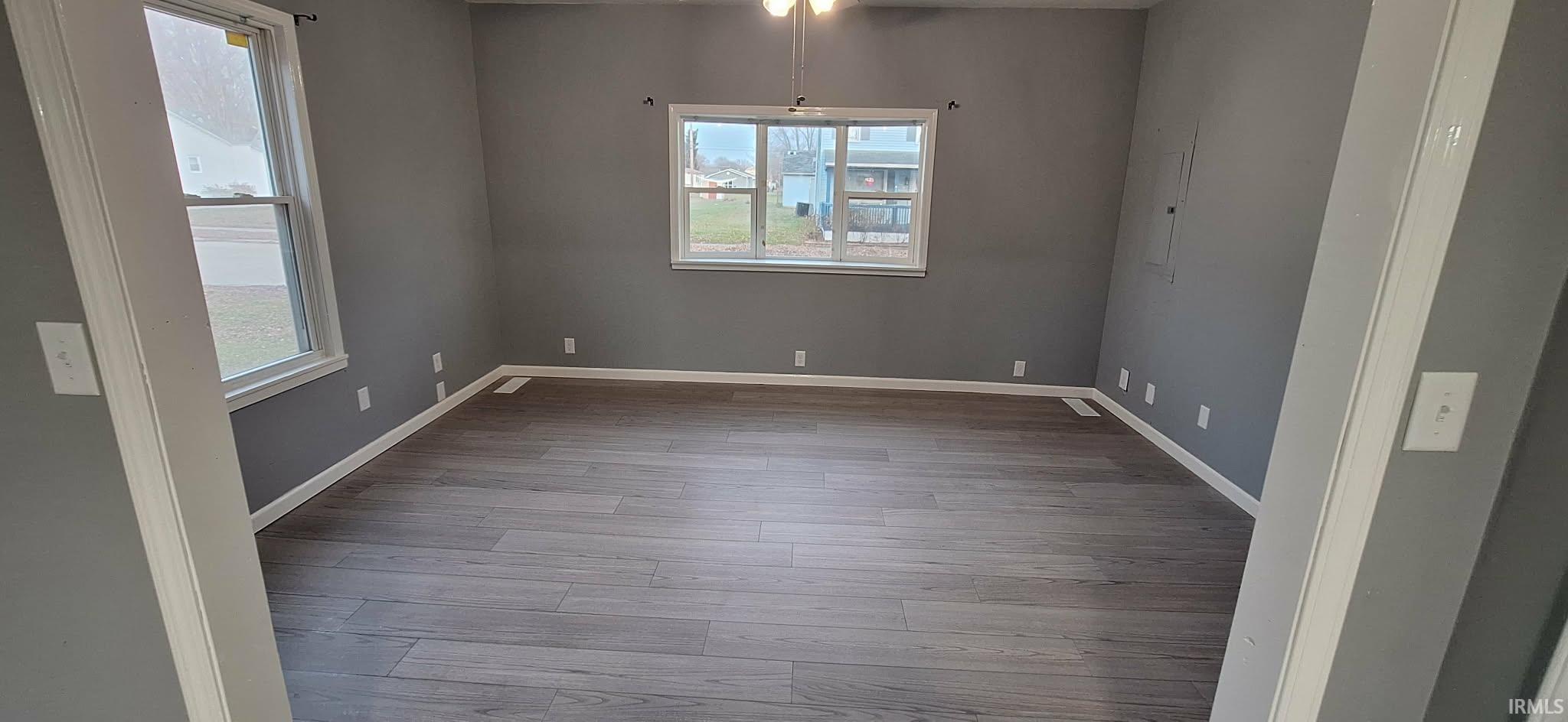Empty room featuring light wood finished floors and baseboards