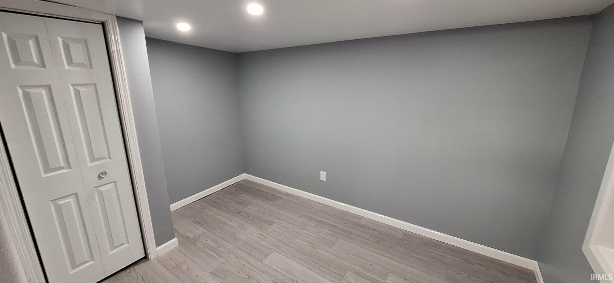 Unfurnished room featuring light wood finished floors and recessed lighting