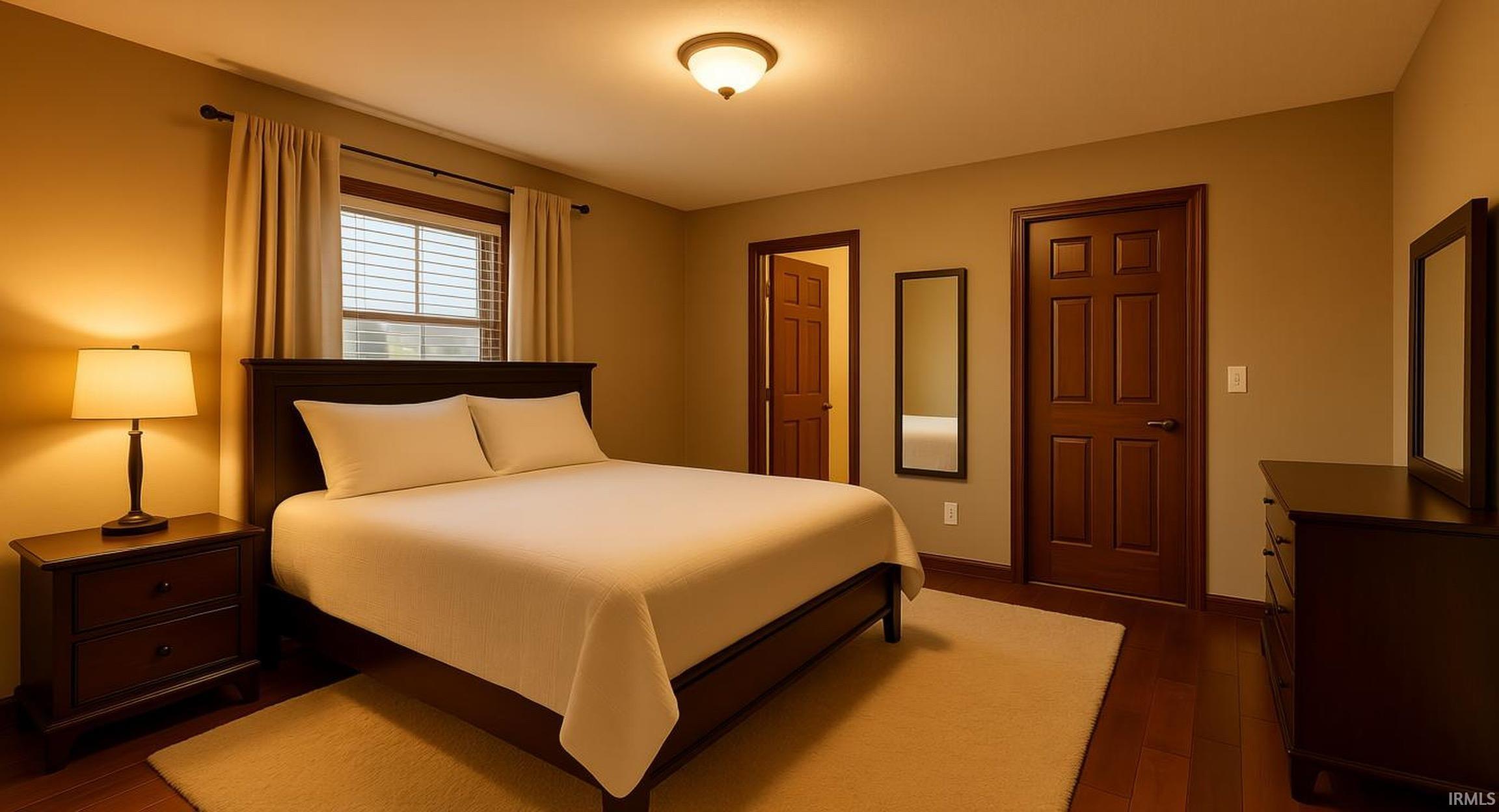 Bedroom featuring dark wood finished floors and baseboards