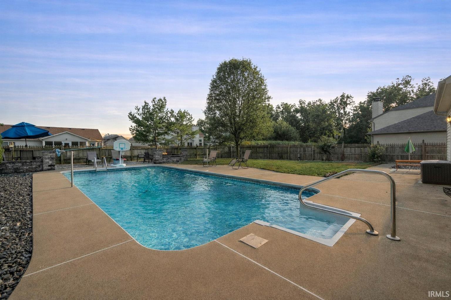 View of pool with a patio area and a fenced backyard