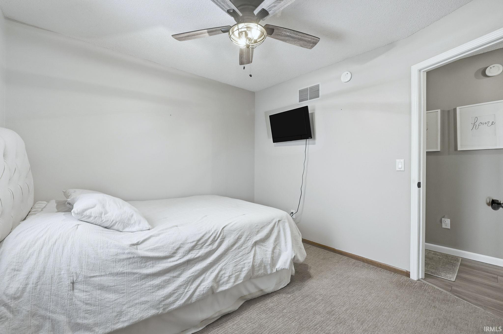 Bedroom featuring ceiling fan and carpet floors