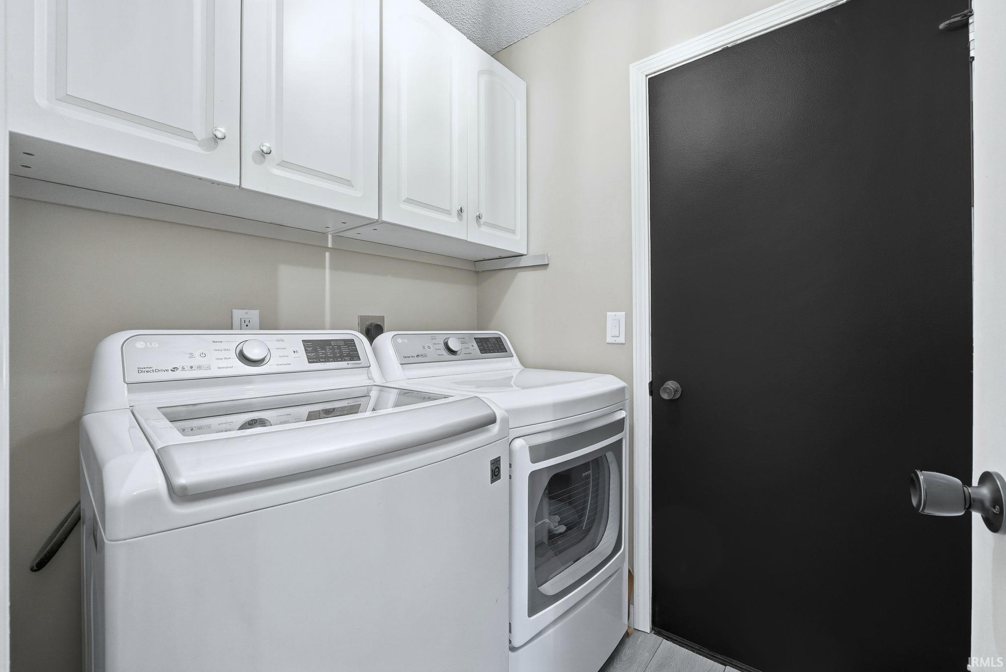 Laundry area with washing machine and clothes dryer and cabinet space
