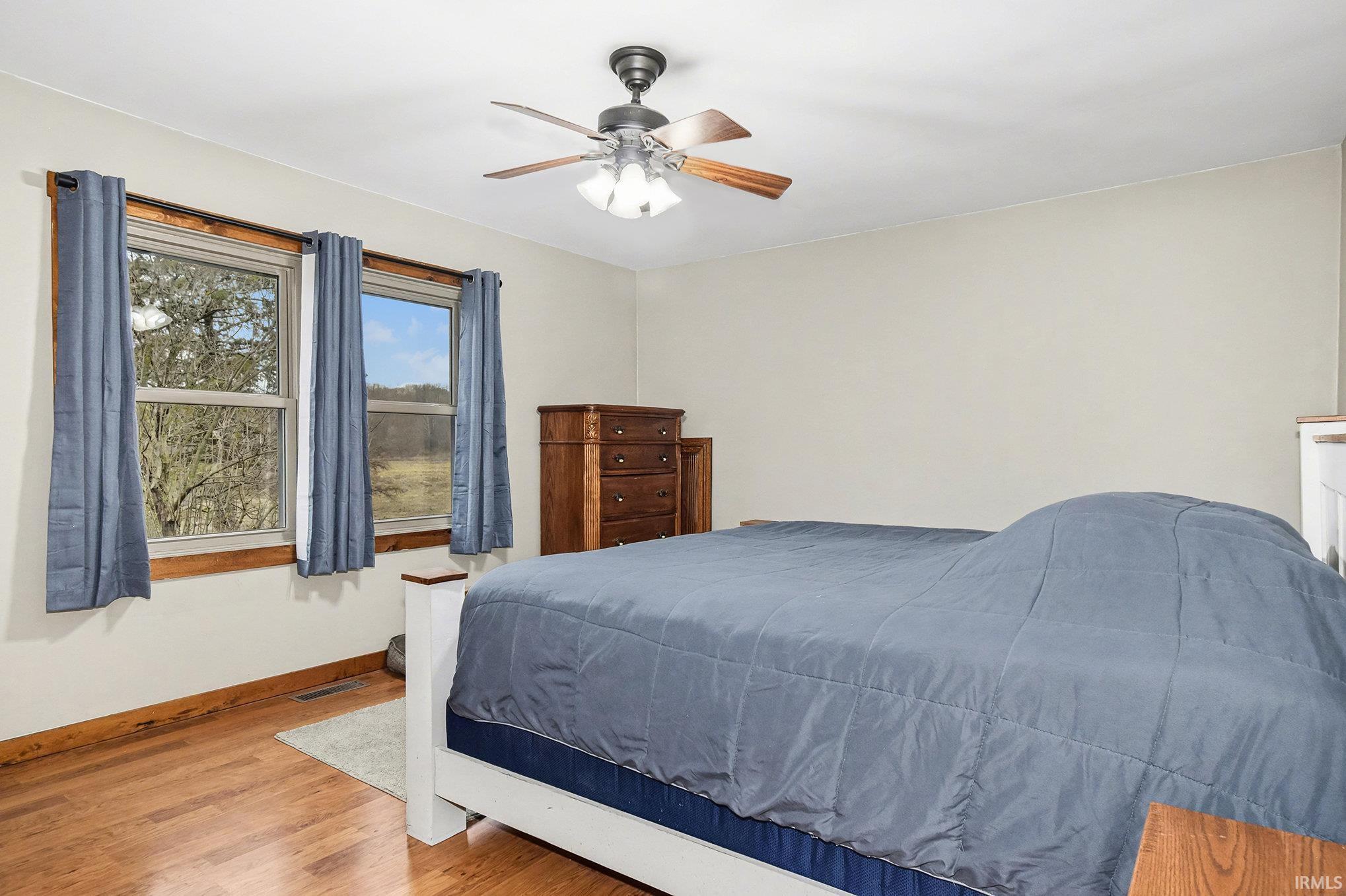 Bedroom featuring wood finished floors and a ceiling fan