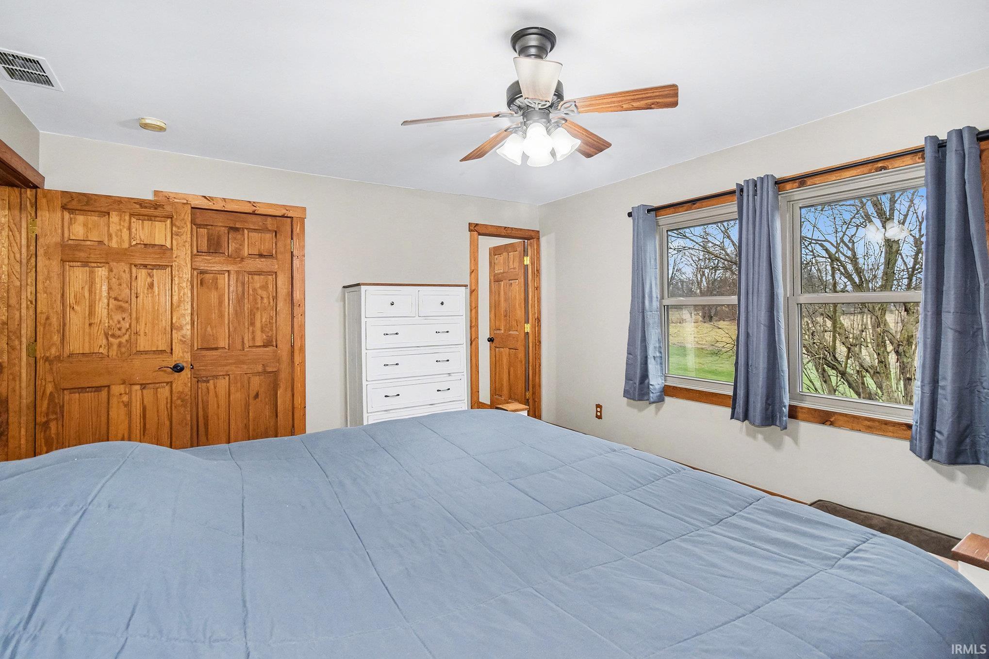 Bedroom with a closet and a ceiling fan