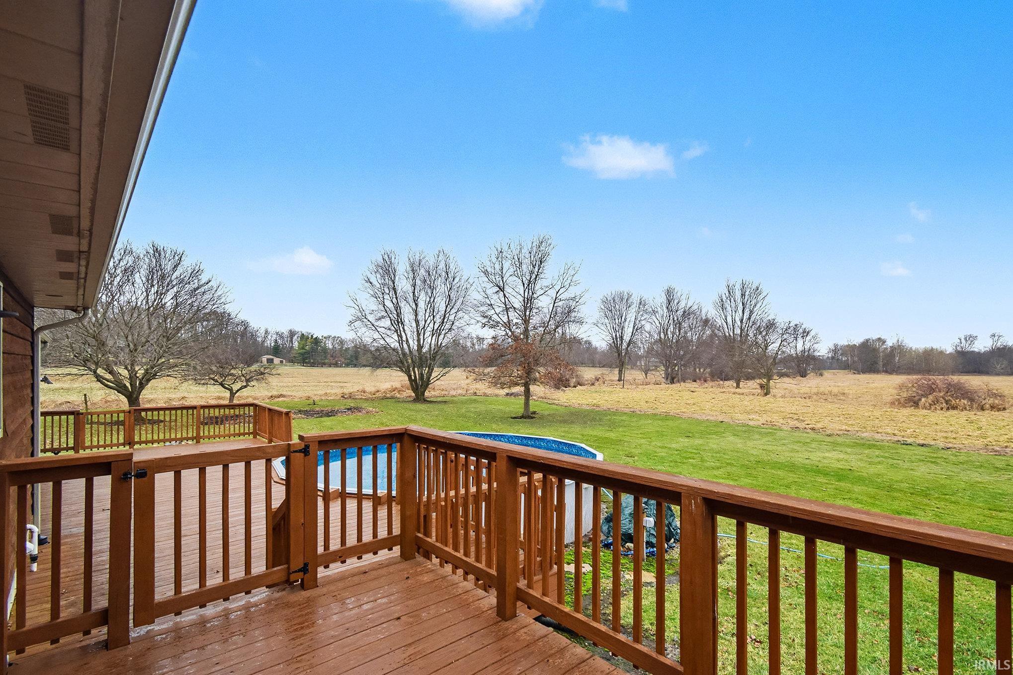 Deck featuring a yard and a view of countryside