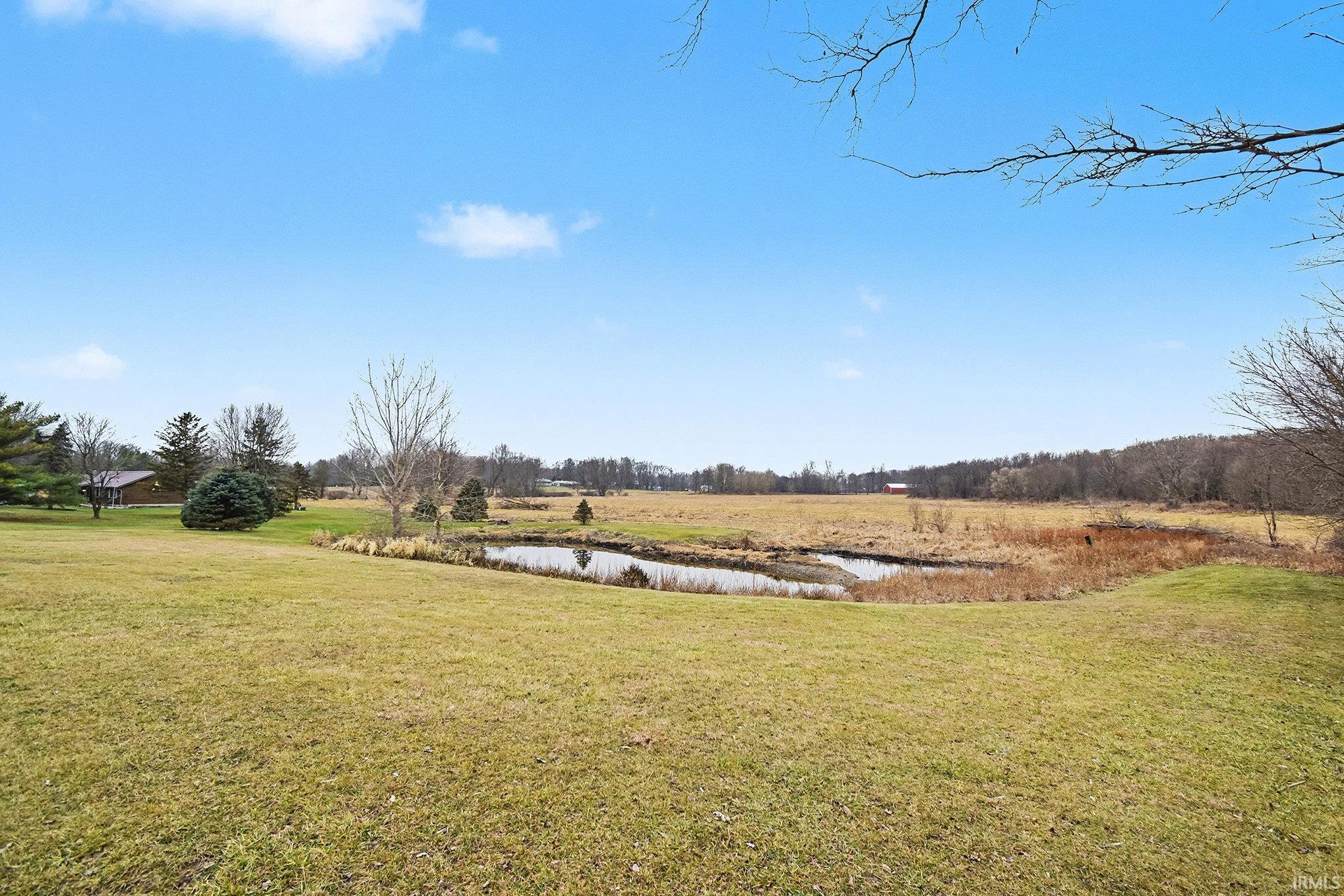View of grassy yard with a water view