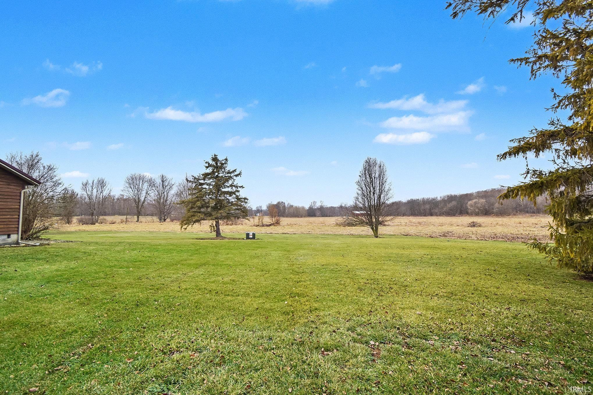 View of green lawn featuring a view of rural / pastoral area