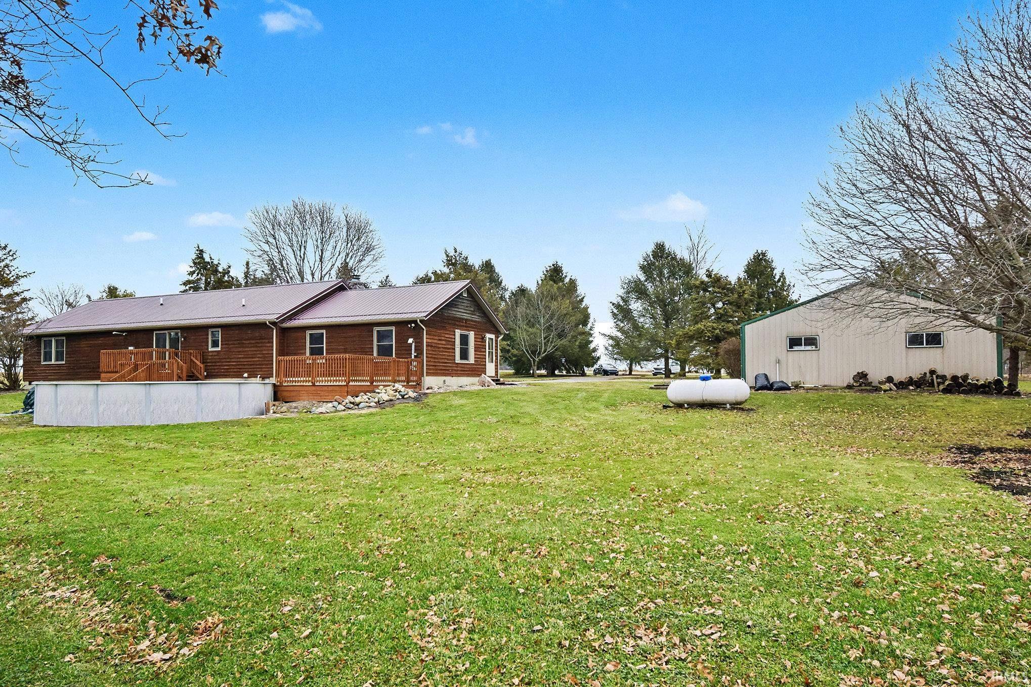 Back of house featuring a yard