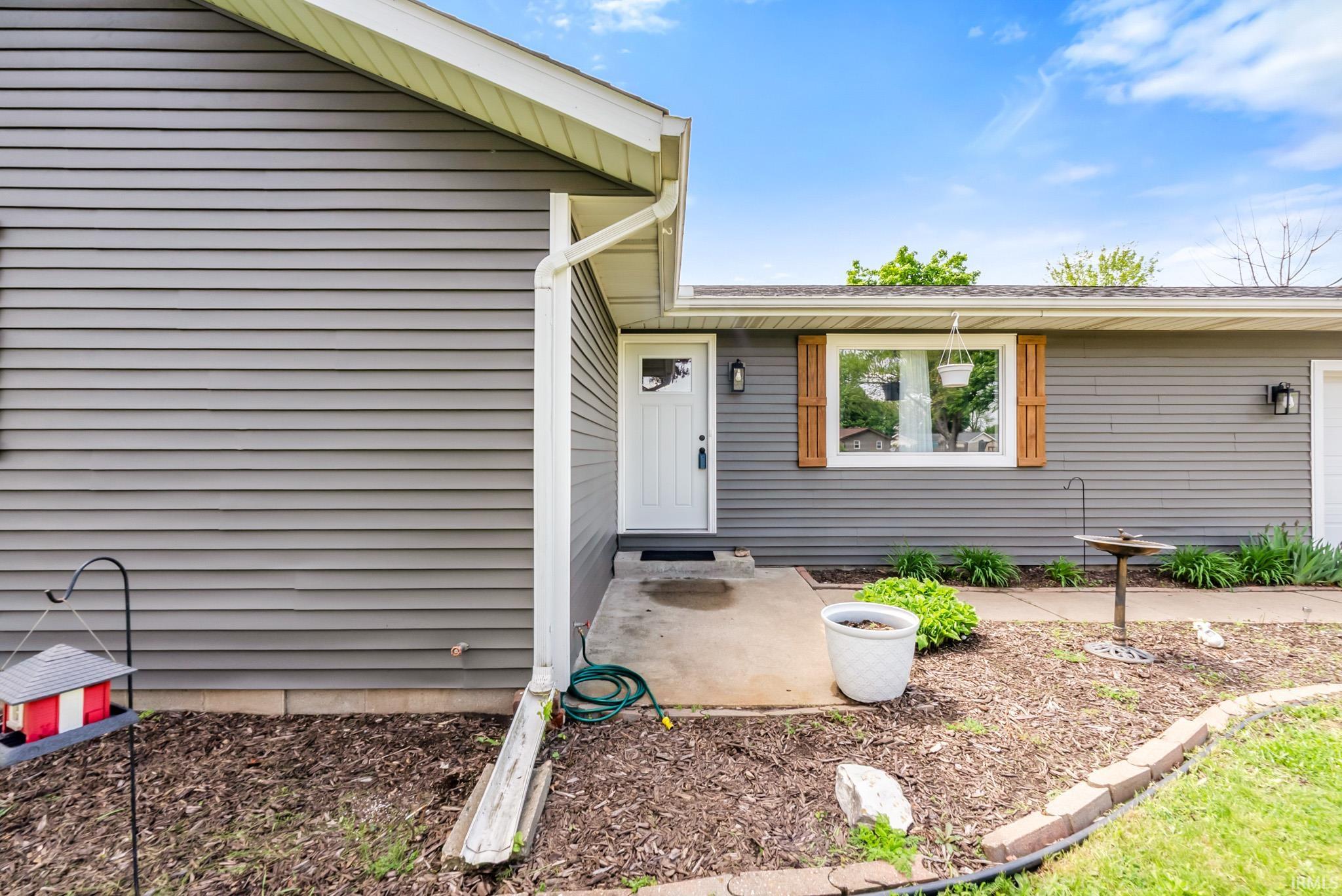Property entrance with a patio area