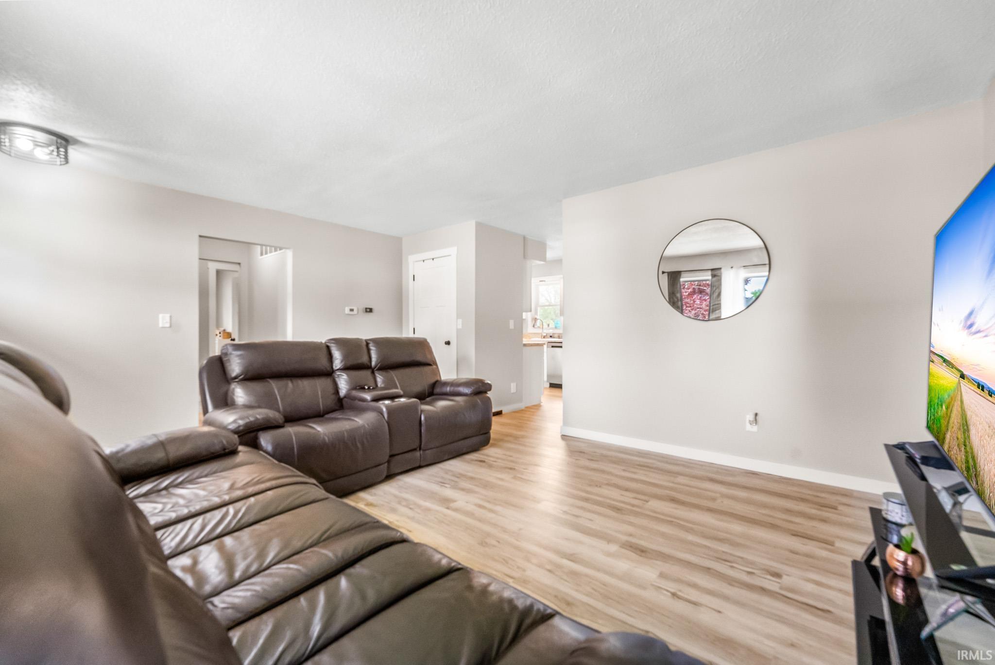 Living area featuring wood finished floors and a textured ceiling