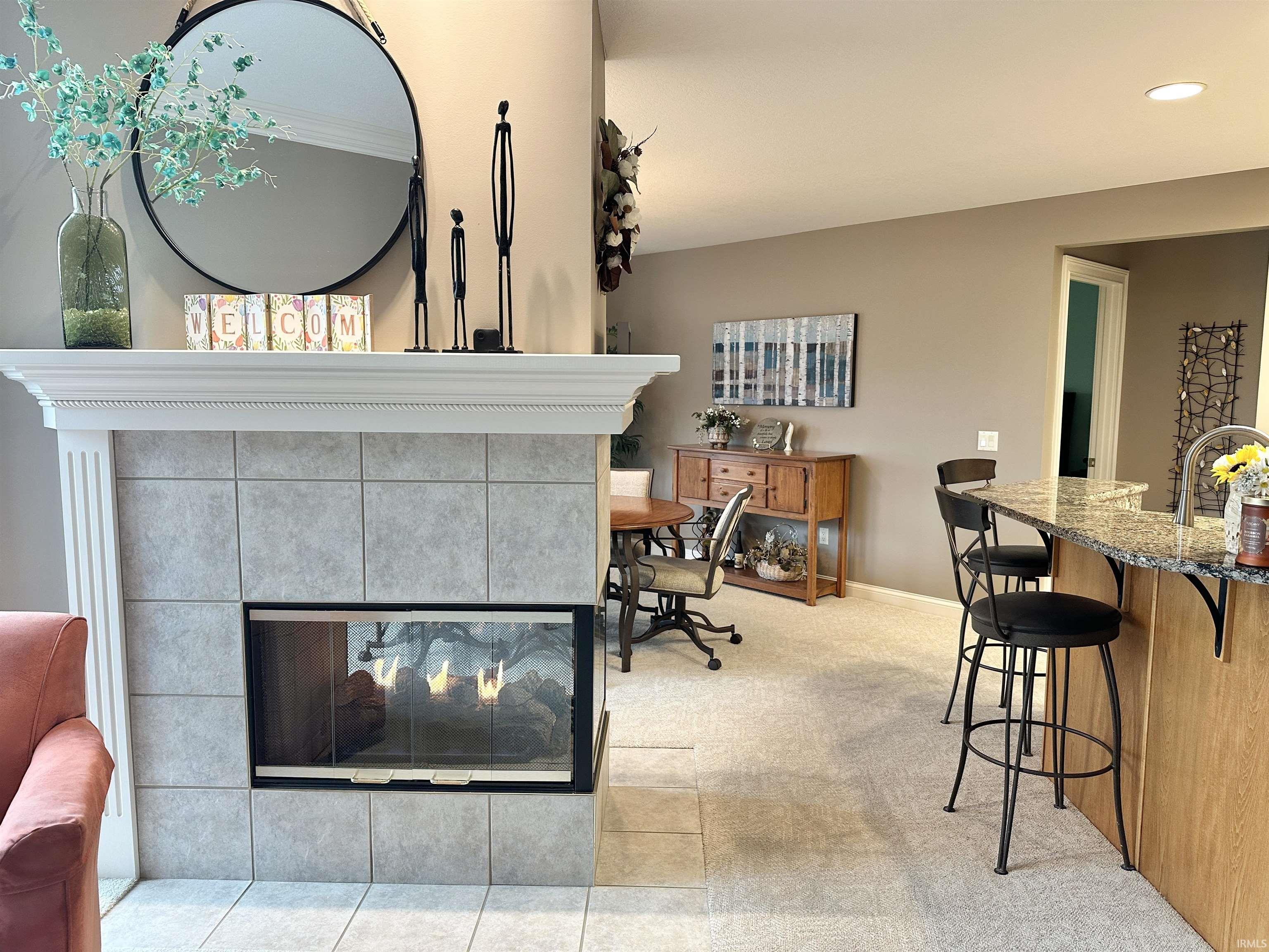 Detailed view of a tile fireplace and recessed lighting