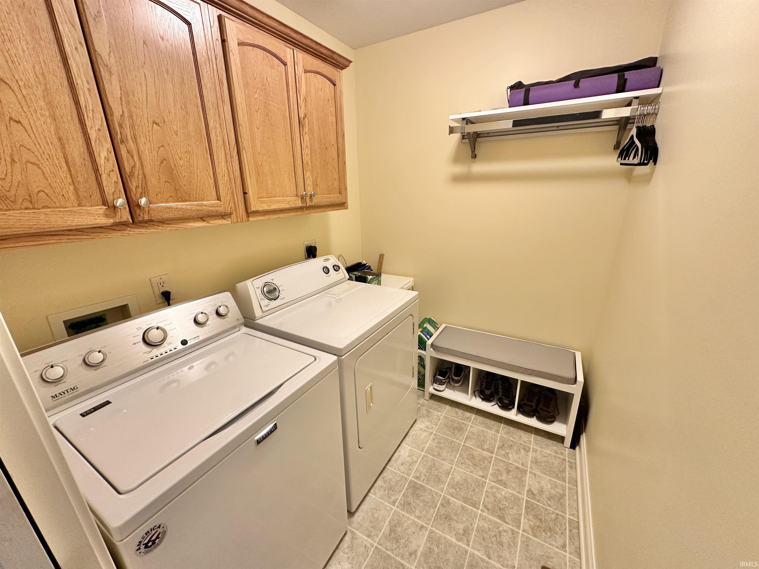 Laundry room featuring cabinet space and washer and dryer