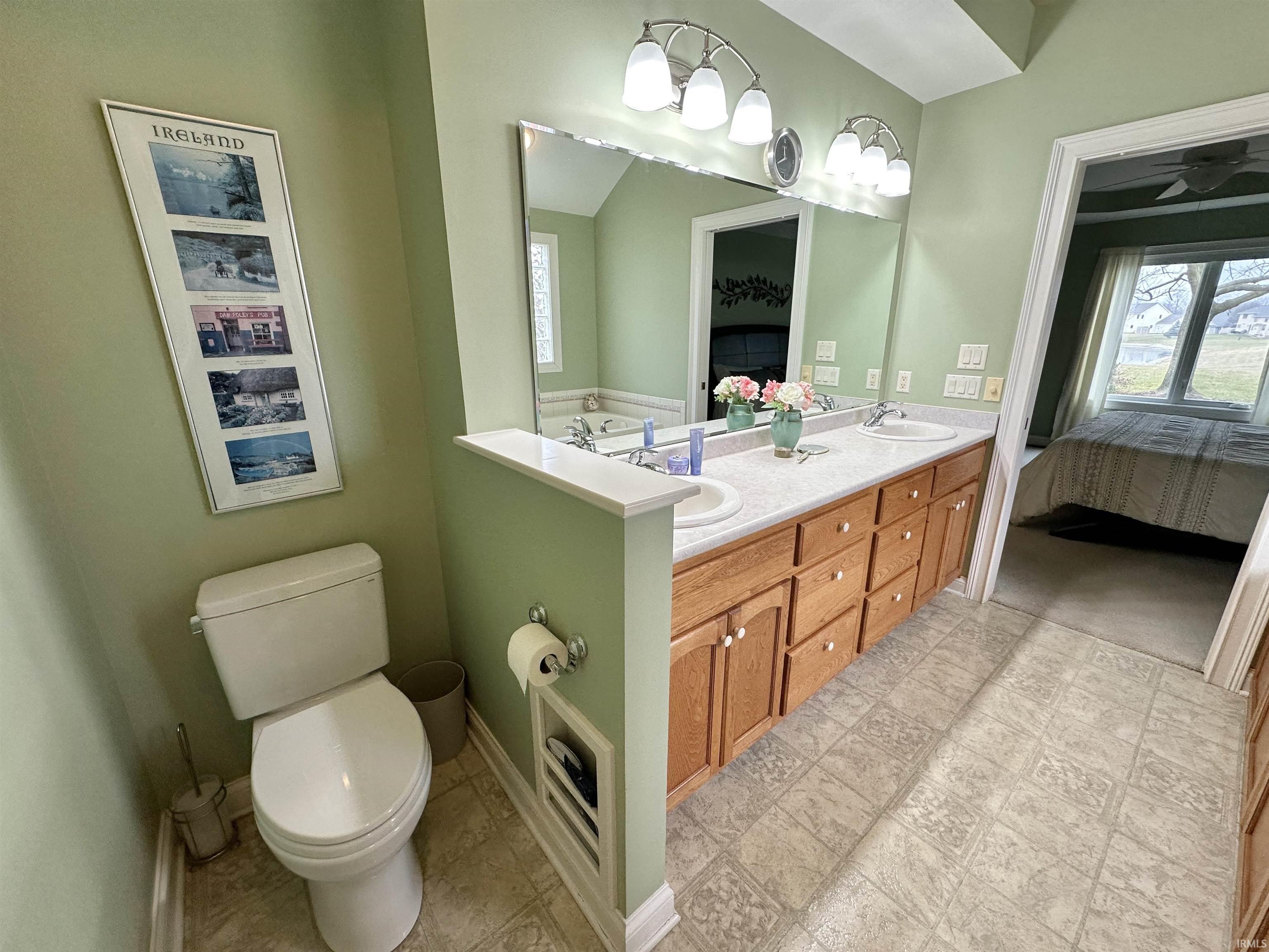 Full bath featuring connected bathroom and double vanity