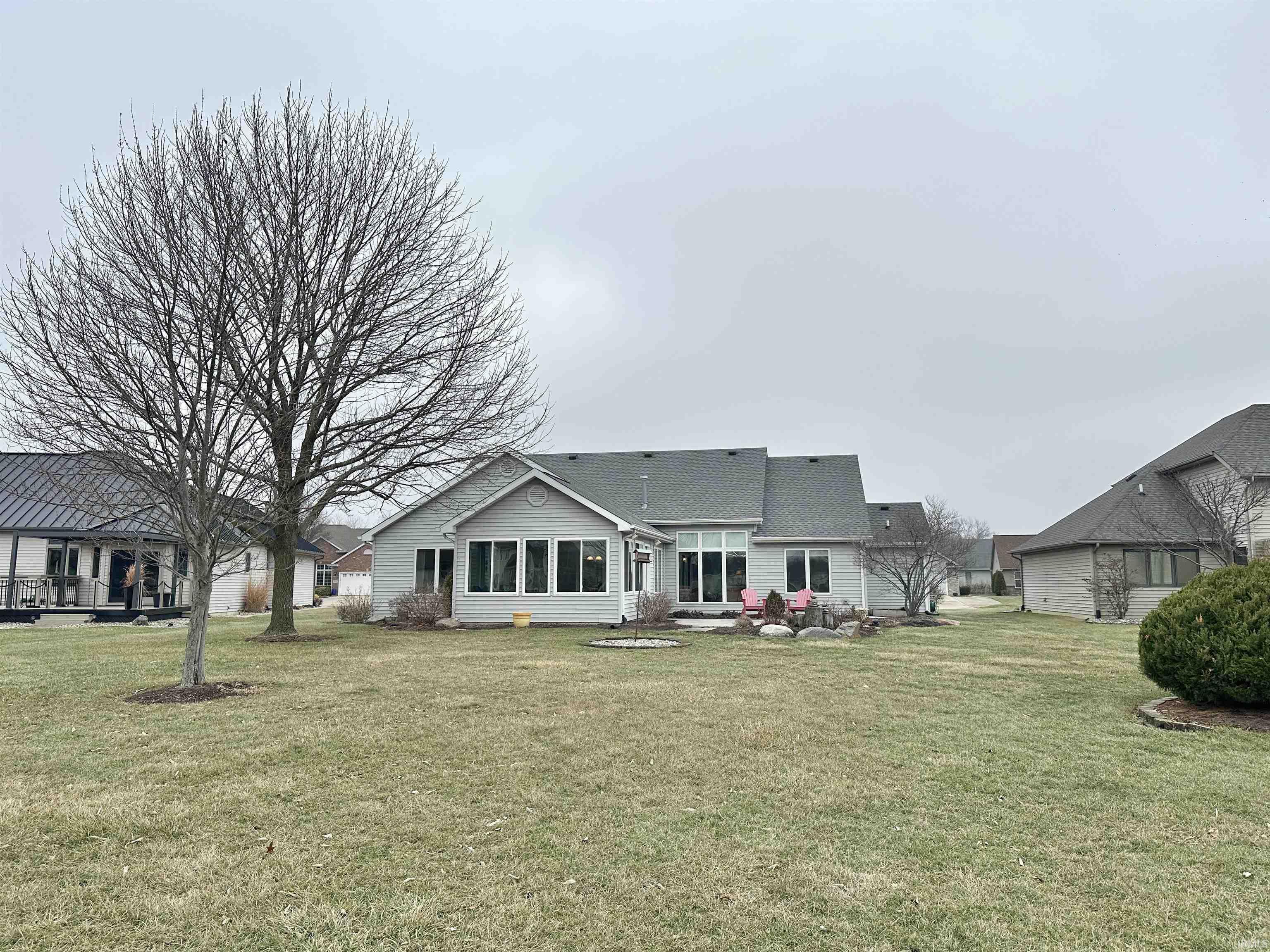 Back of house featuring a yard, a sunroom, and a patio