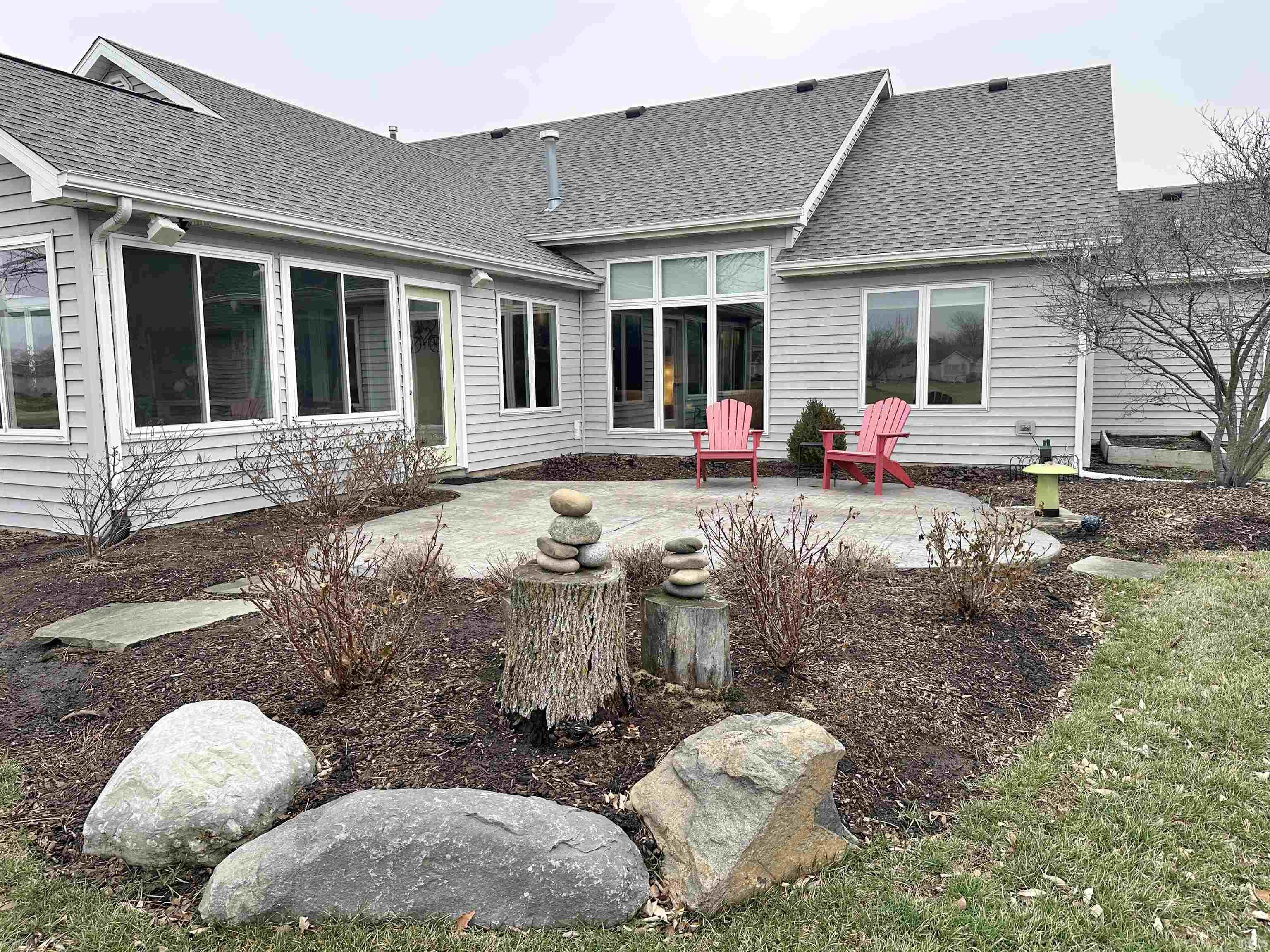 Rear view of property with roof with shingles and a patio area