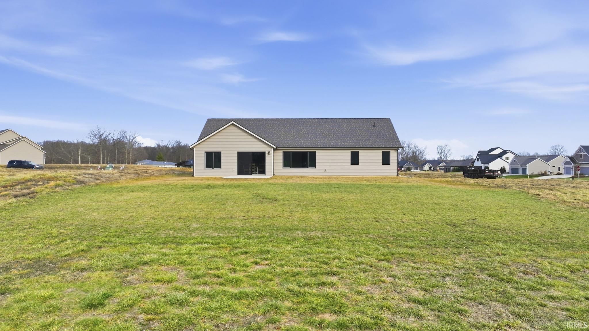 Rear view of property featuring a lawn