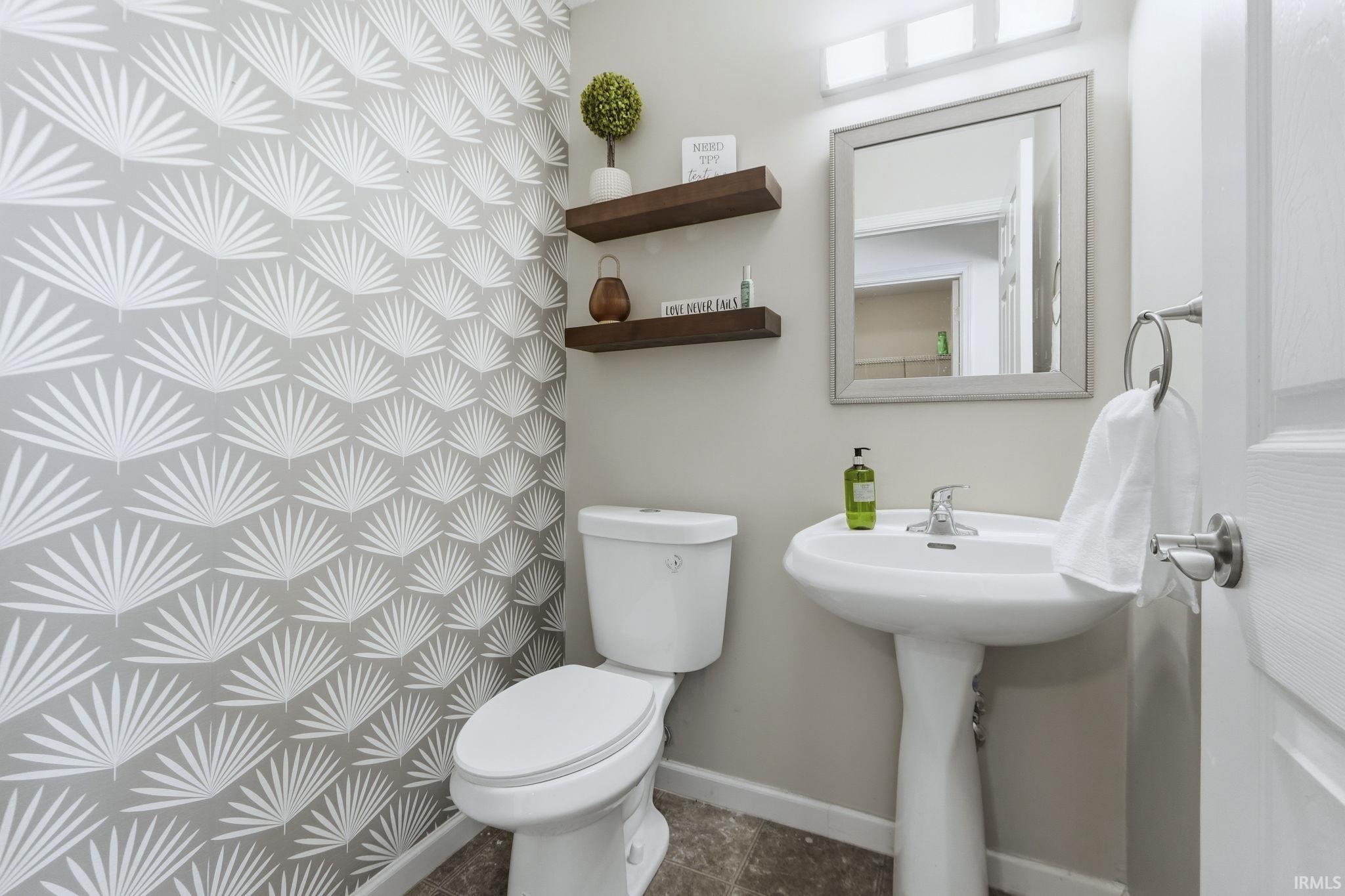 Bathroom featuring toilet and baseboards