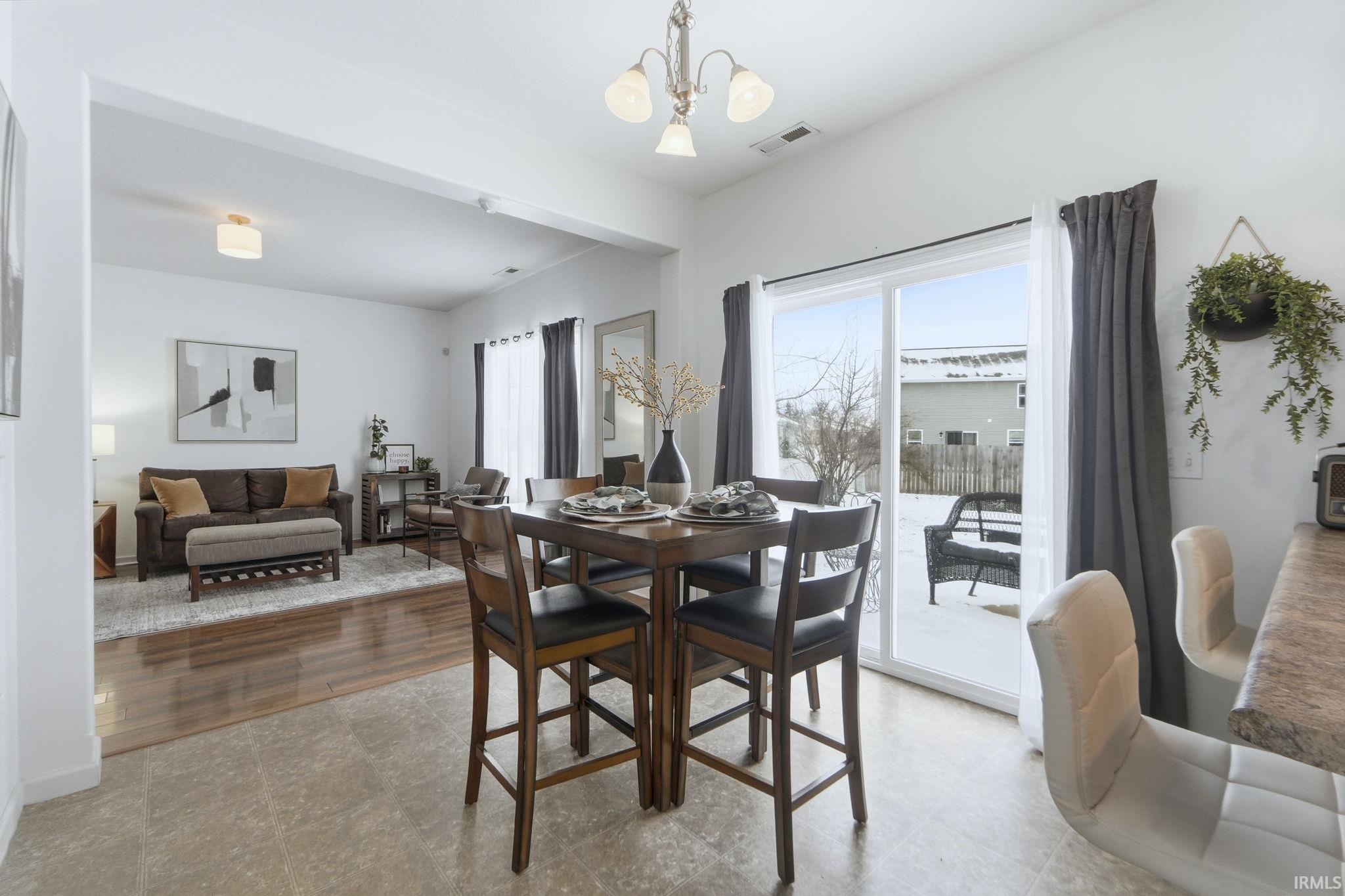 Dining room featuring a chandelier and tile patterned floors