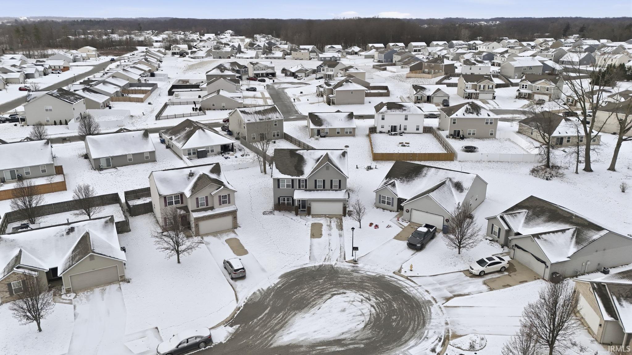 Snowy aerial view featuring a residential view