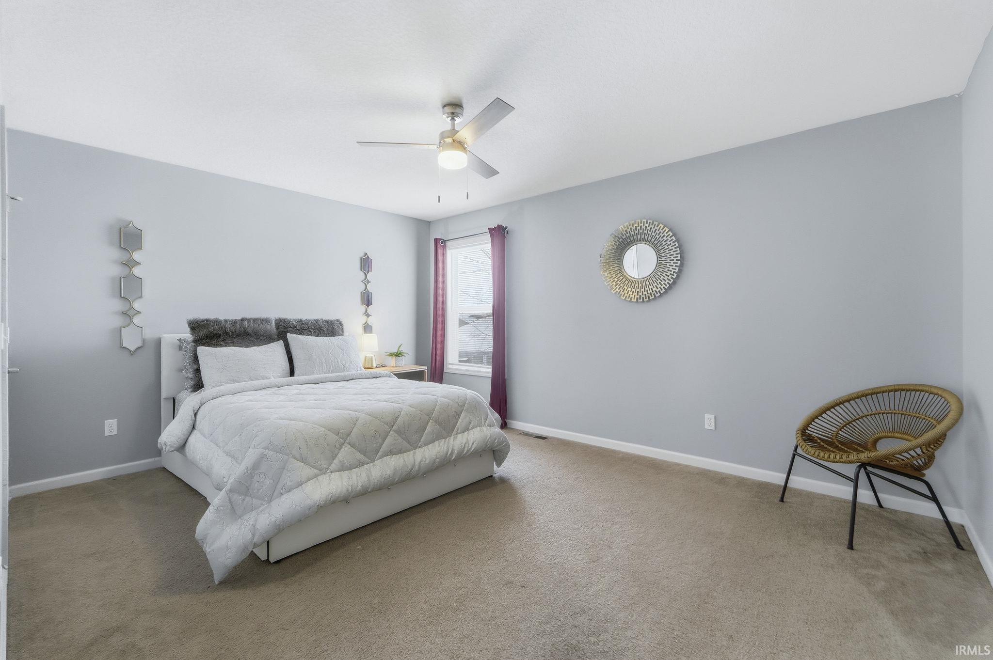 Bedroom with carpet flooring and a ceiling fan