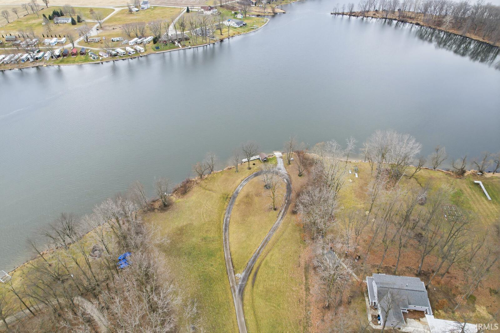 Aerial overview of property's location with a nearby body of water
