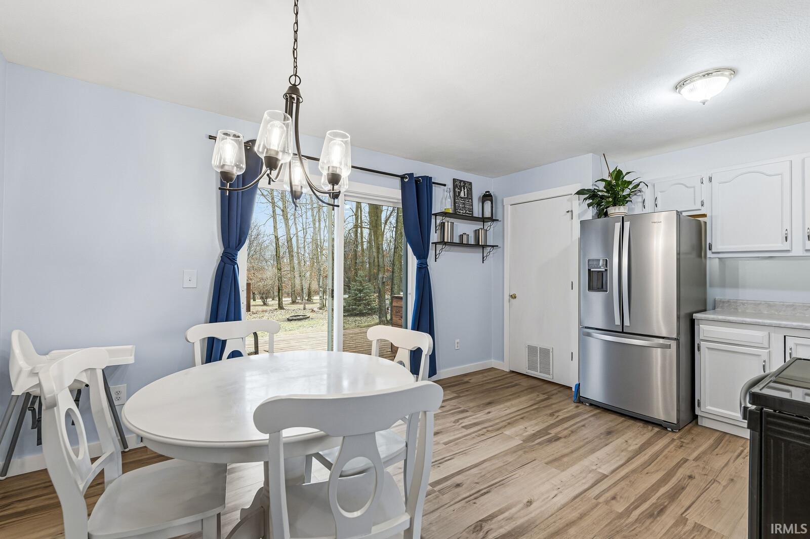 Dining area featuring a chandelier and light wood-style floors