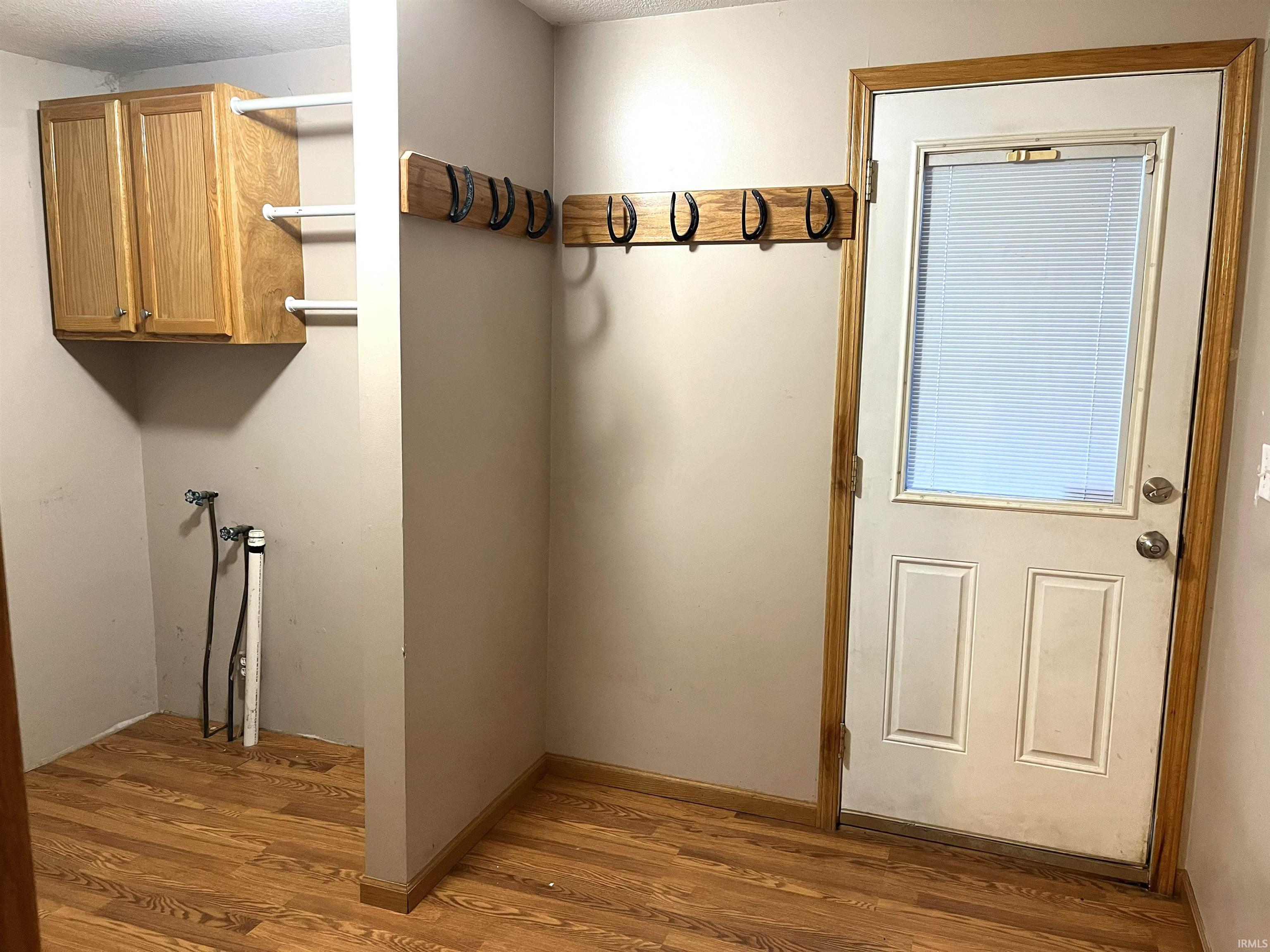 Laundry room featuring light wood-style floors and hookup for a washing machine