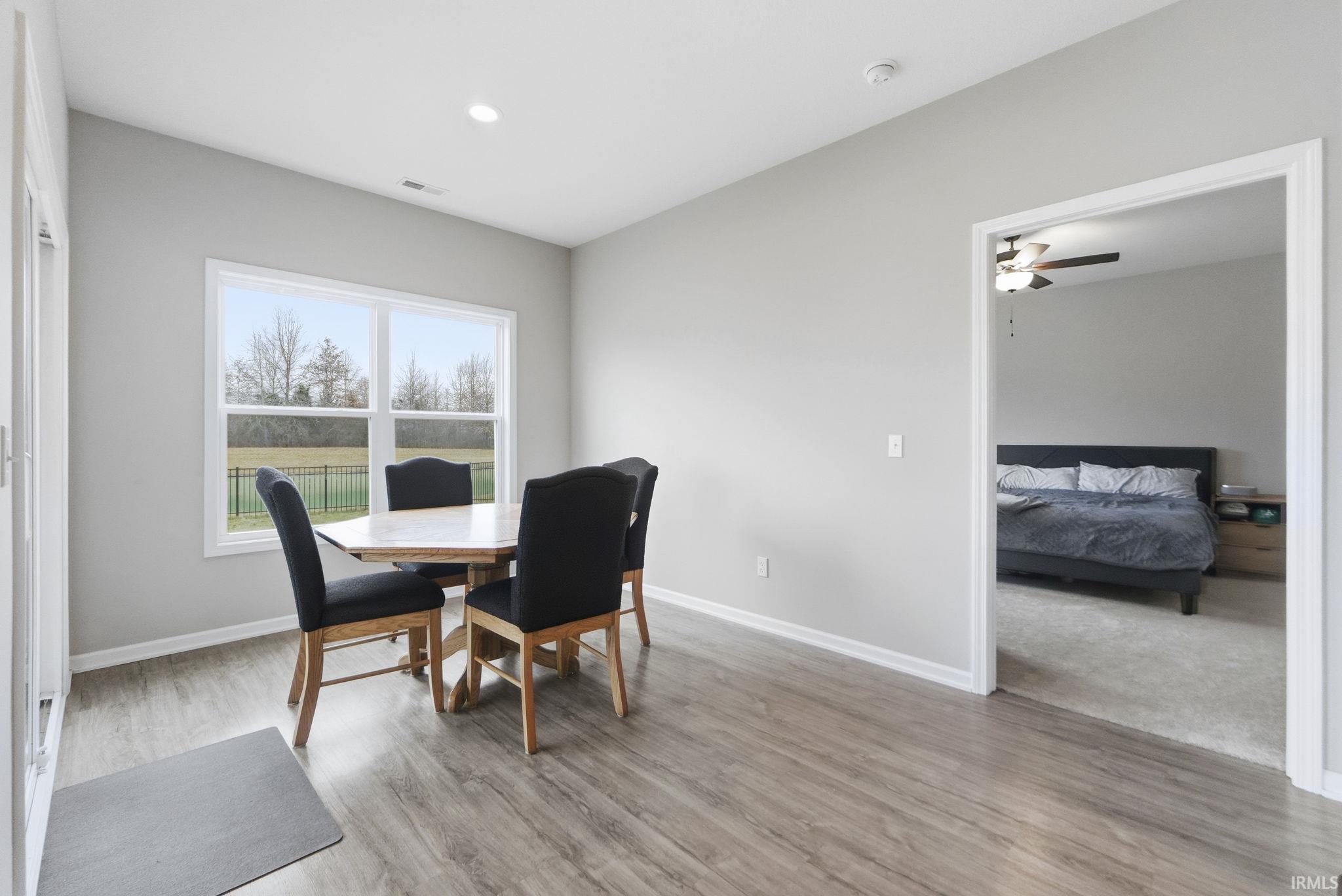 Dining area with light wood-style flooring, ceiling fan, and recessed lighting