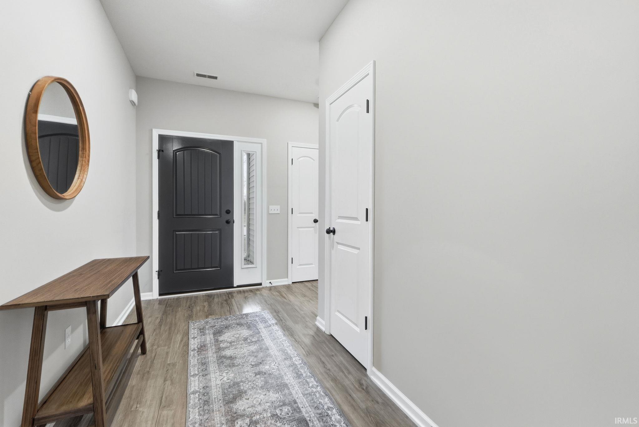 Entrance foyer featuring light wood-style flooring