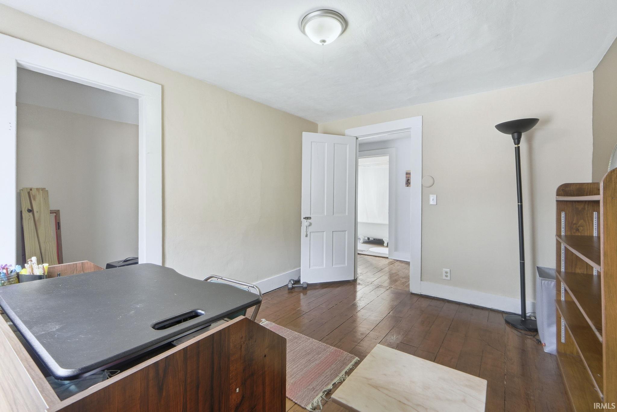 Office with hardwood / wood-style flooring and baseboards