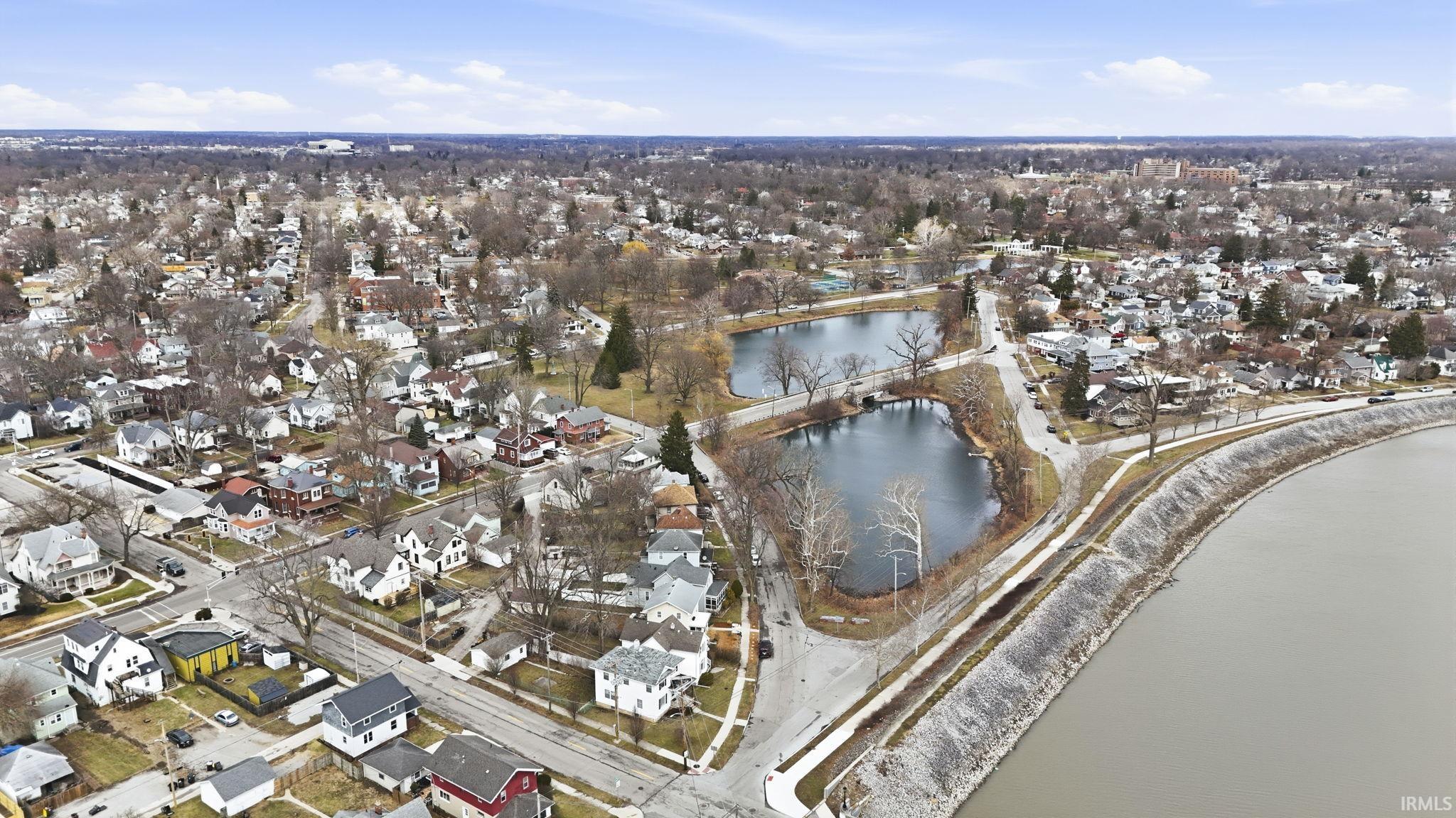 View of property location with nearby suburban area and a nearby body of water