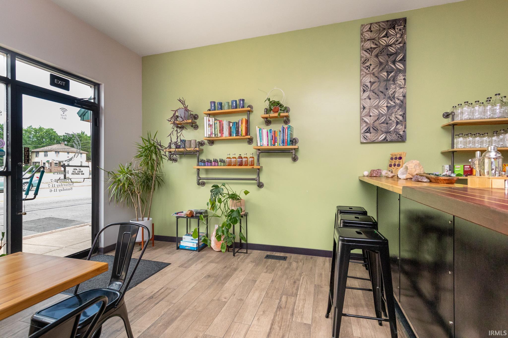 Home office featuring a bar and light wood finished floors