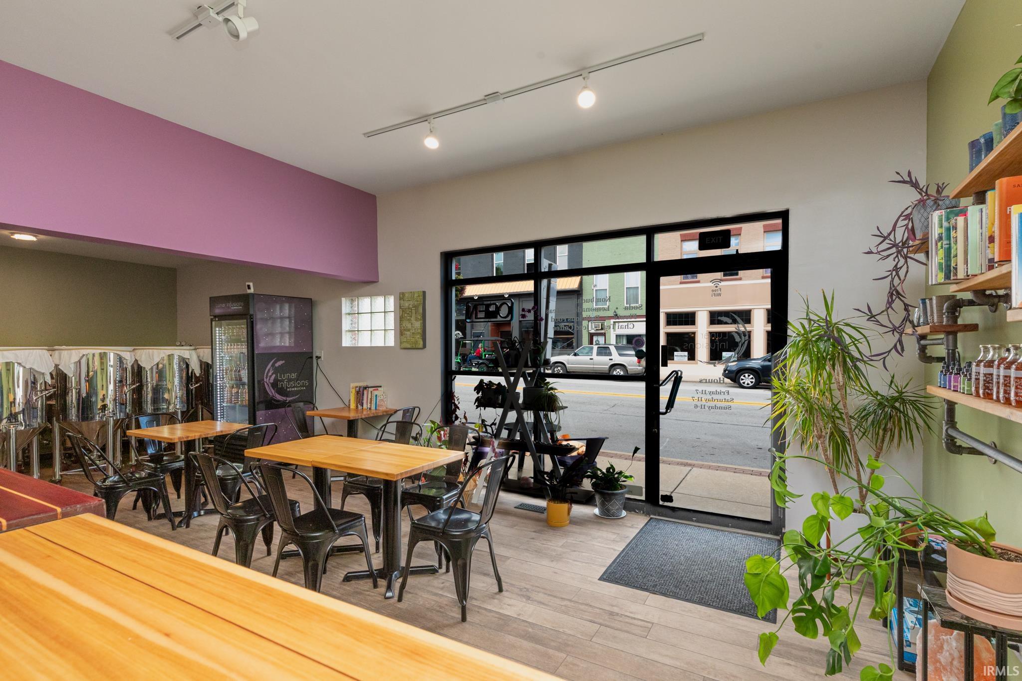 Dining space featuring track lighting and light wood-style flooring