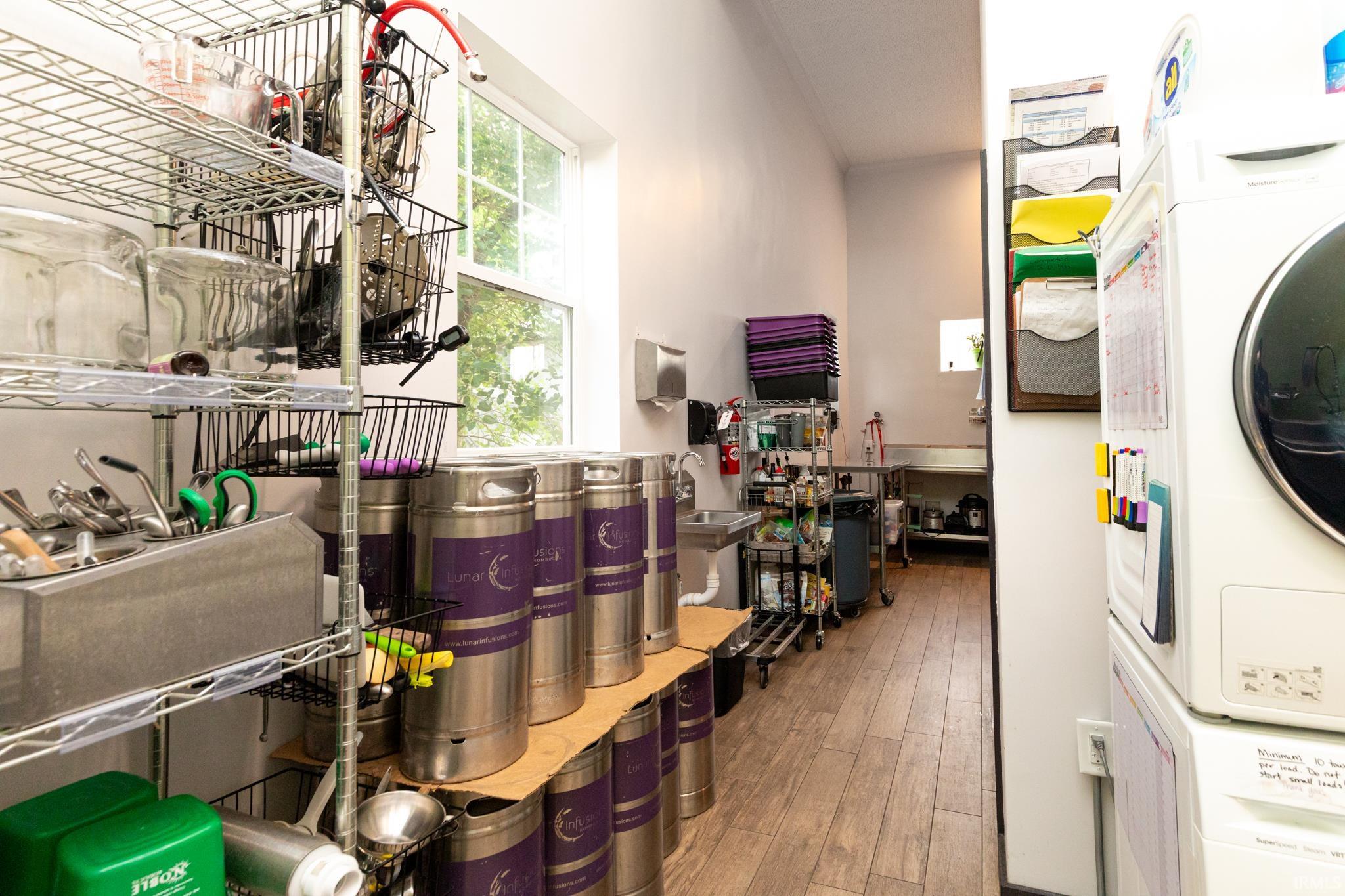 Storage area featuring stacked washer / drying machine