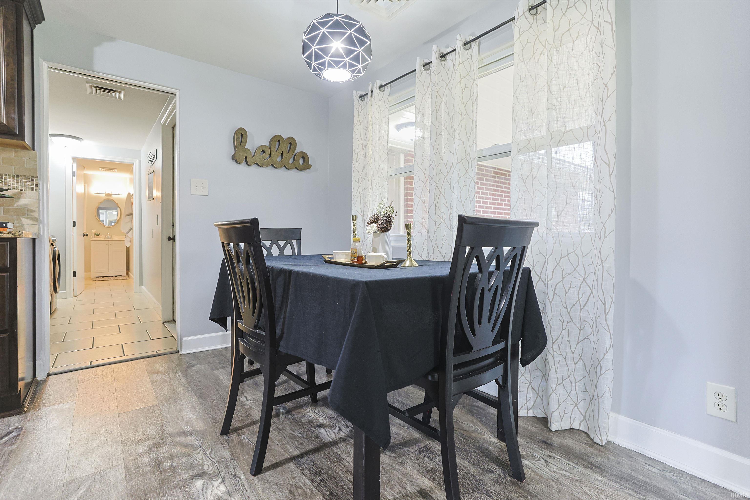 Dining area with light wood-style flooring and baseboards
