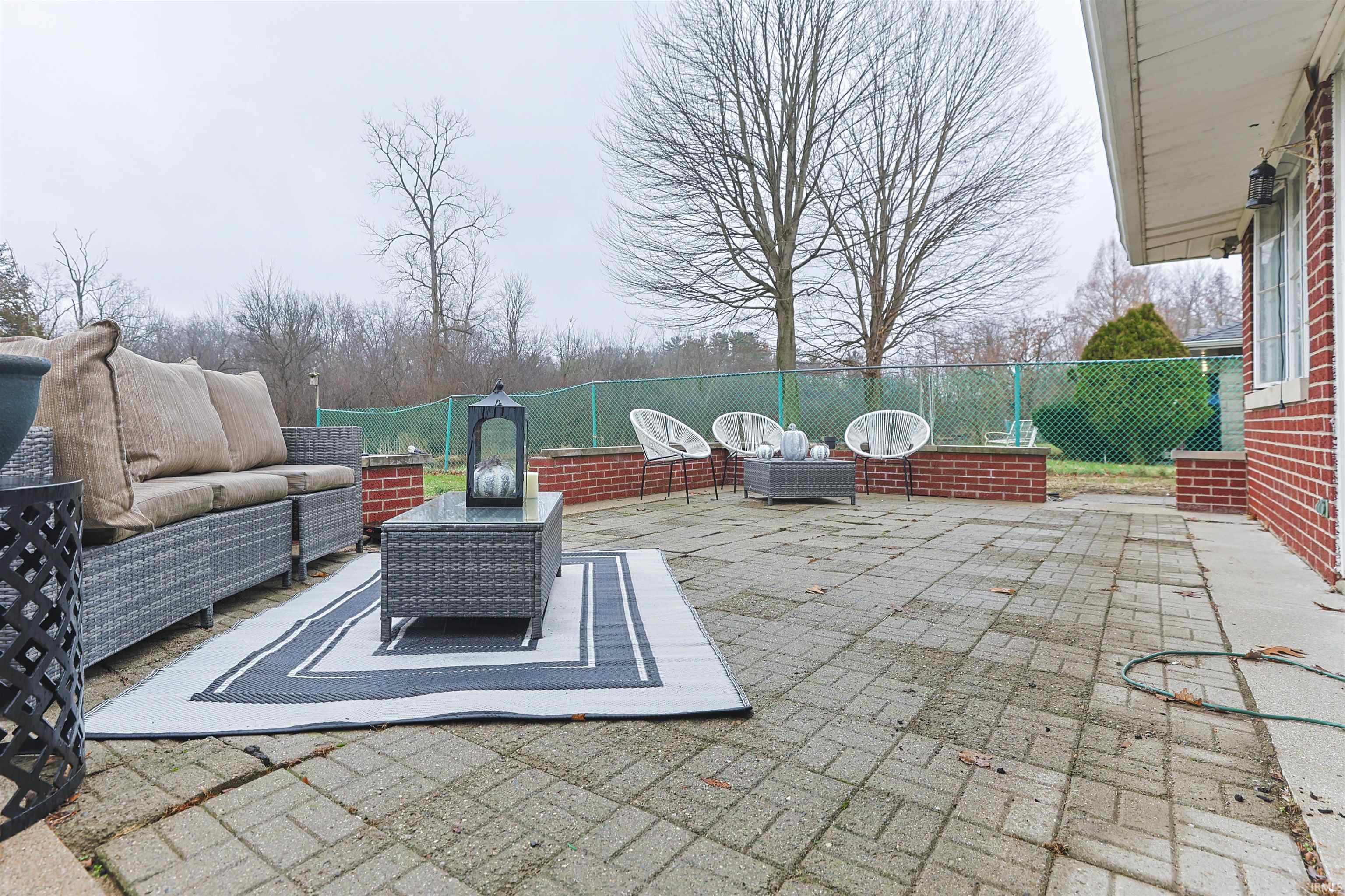 Fenced backyard with a patio and outdoor lounge area