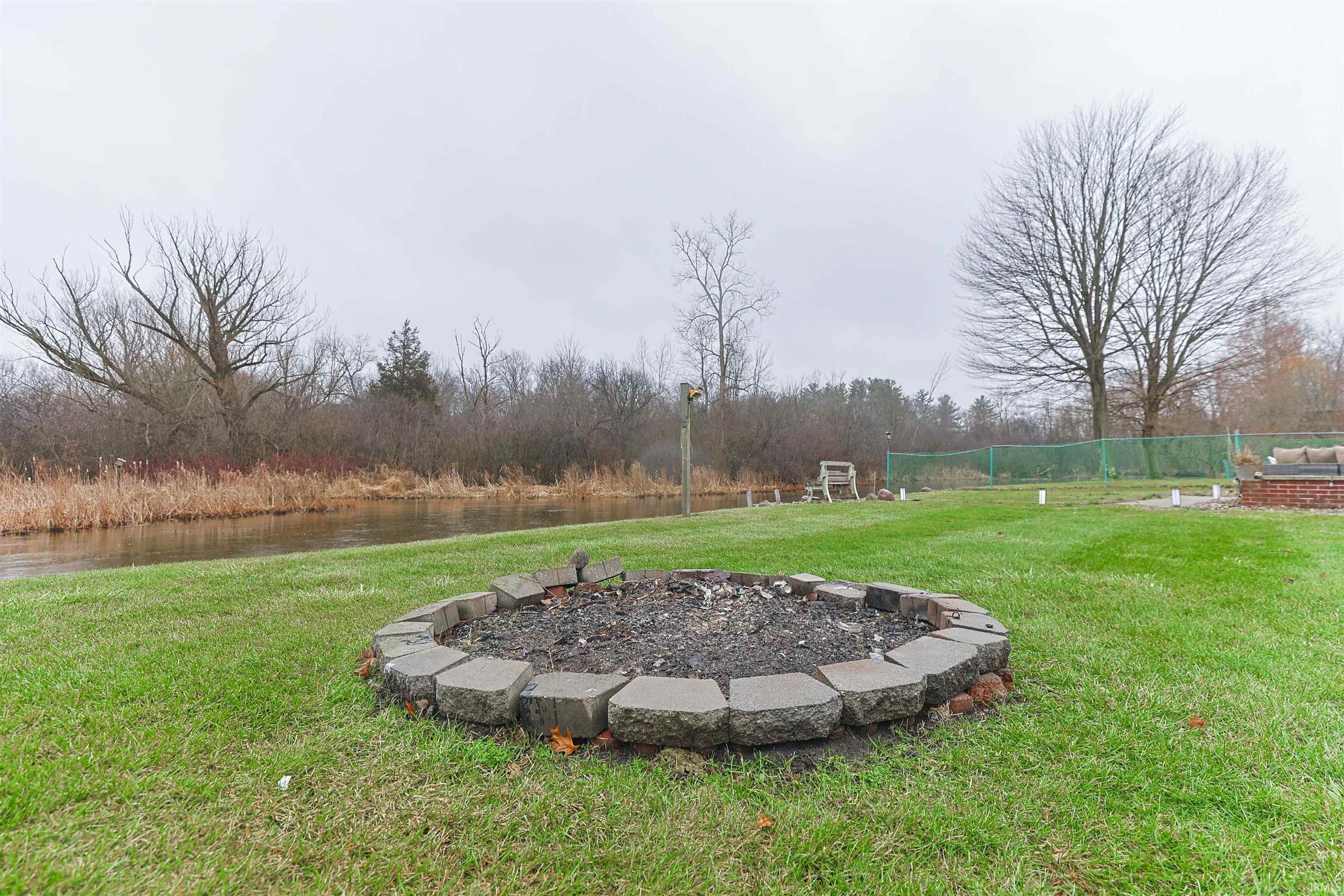 View of yard featuring an outdoor fire pit and a patio