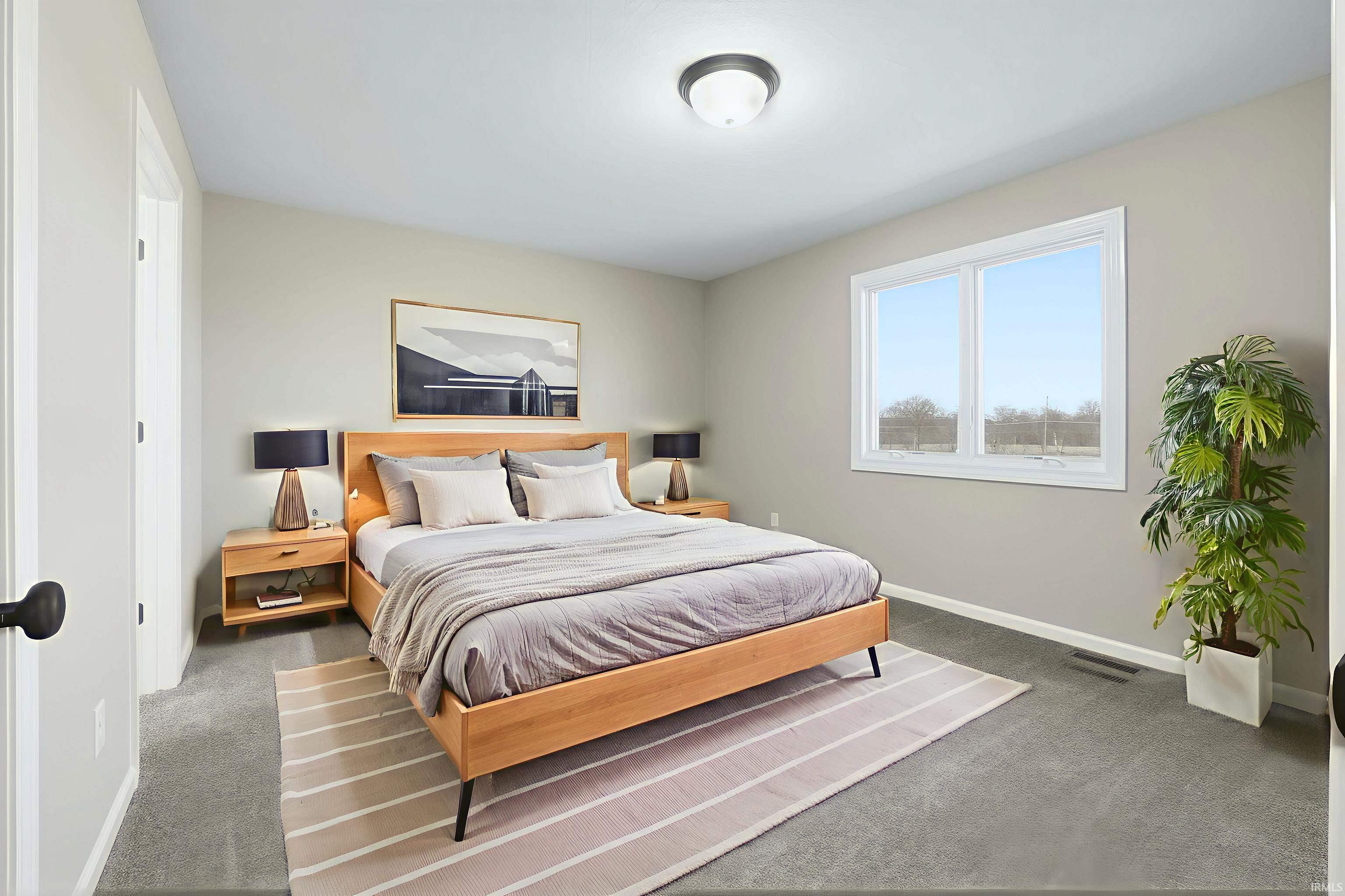 Carpeted bedroom featuring baseboards