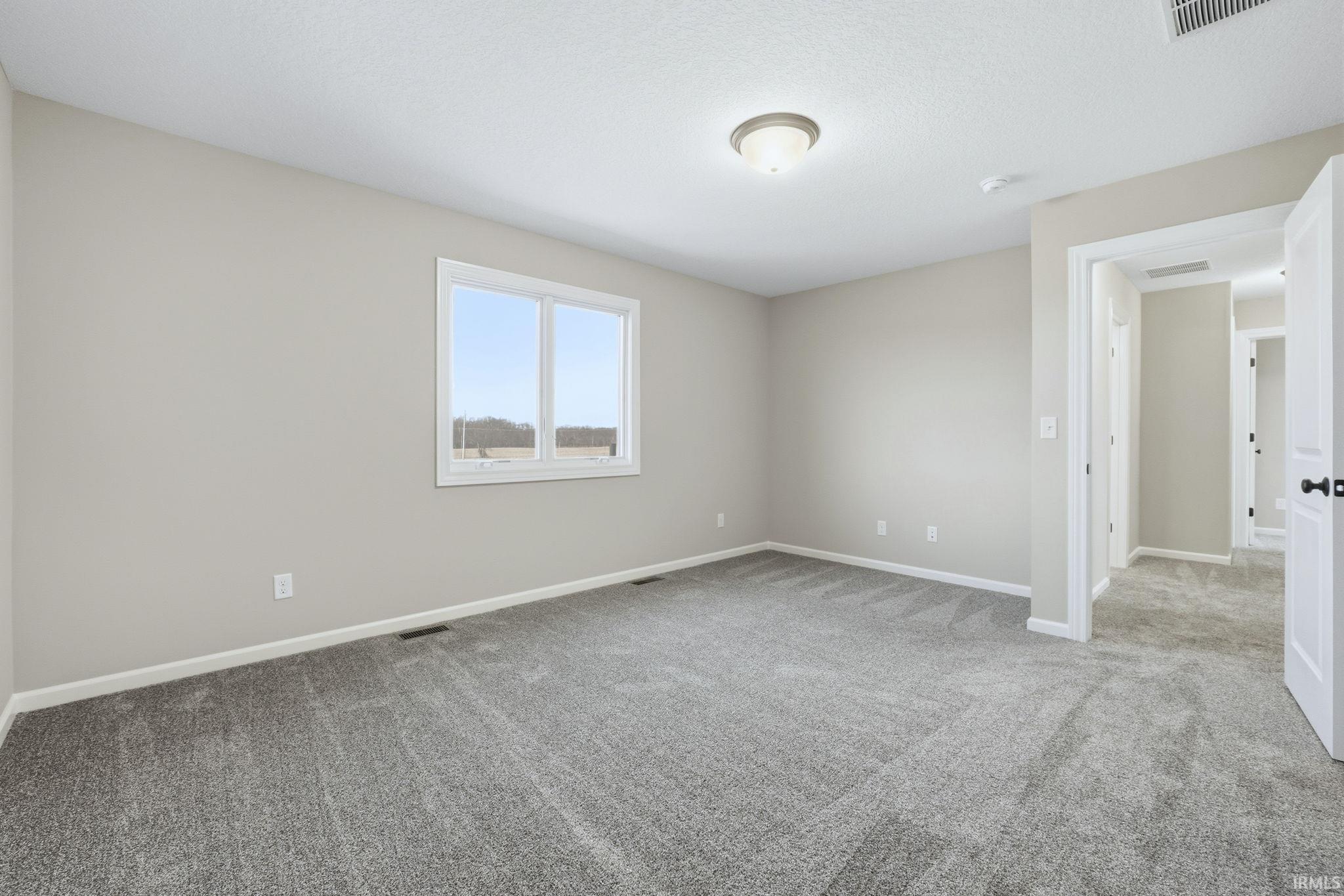 Spare room with light colored carpet